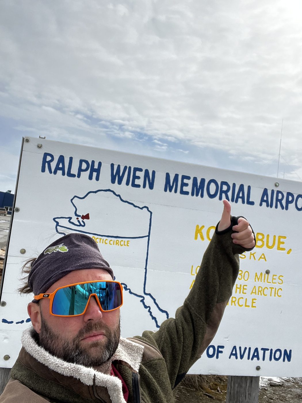 At the Kotzebue, Alaska airport sign, above the Arctic Circle